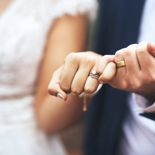 Cropped shot of an unrecognizable newlywed couple doing a pinky swear gesture on their wedding day